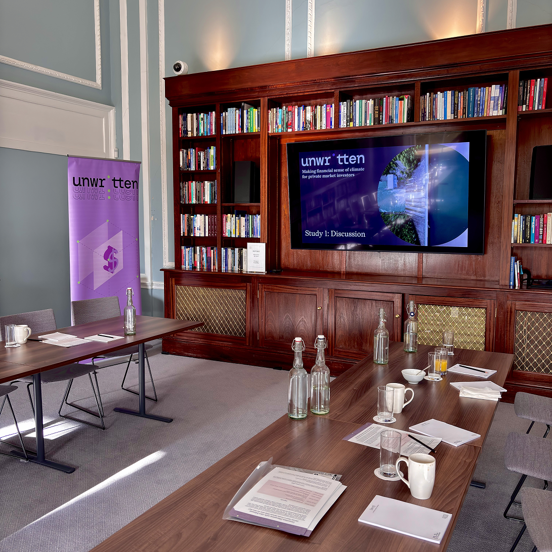 Event room with an Unwritten banner and presentation in the background.