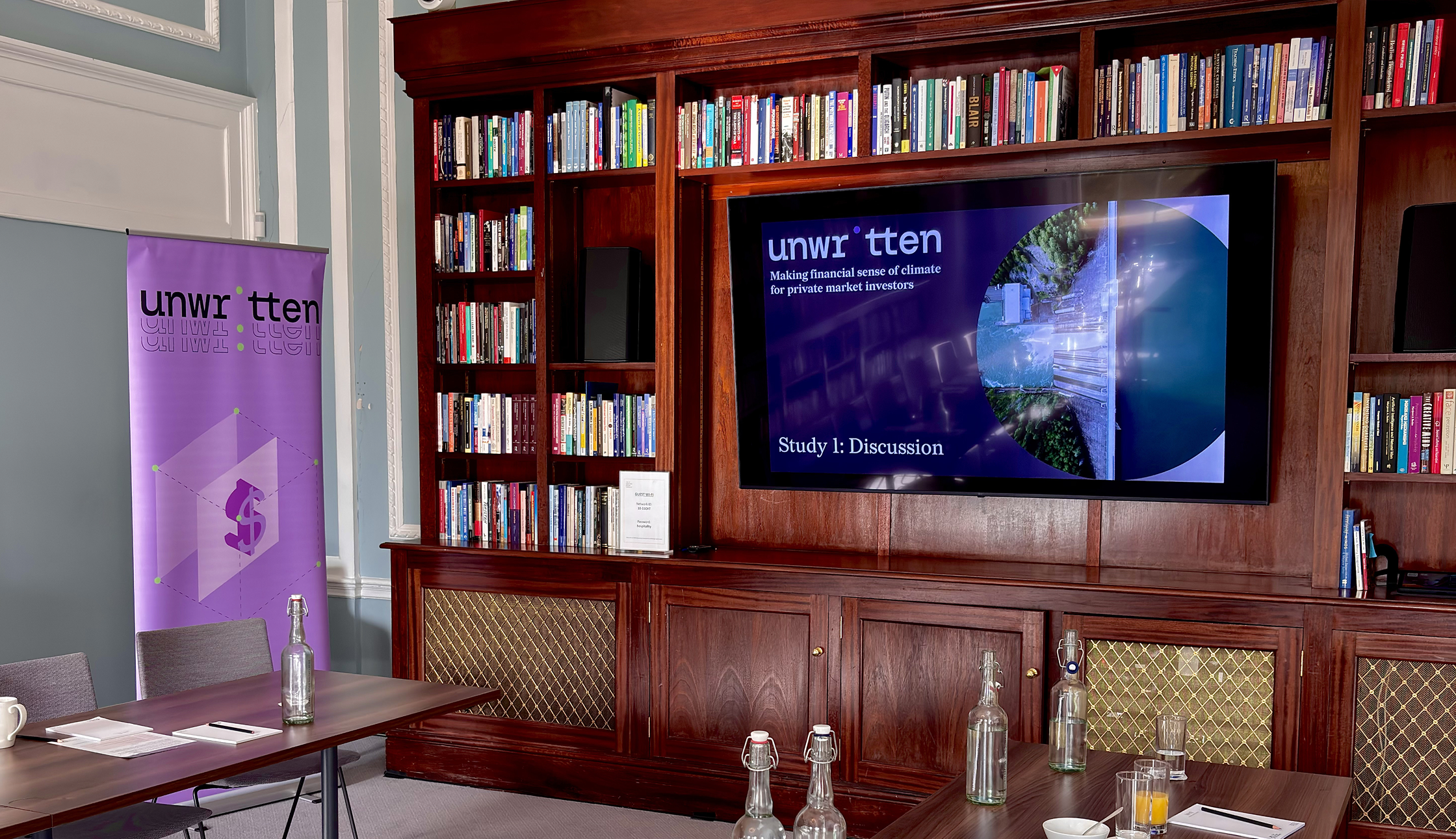 Event room with an Unwritten banner and presentation in the background.