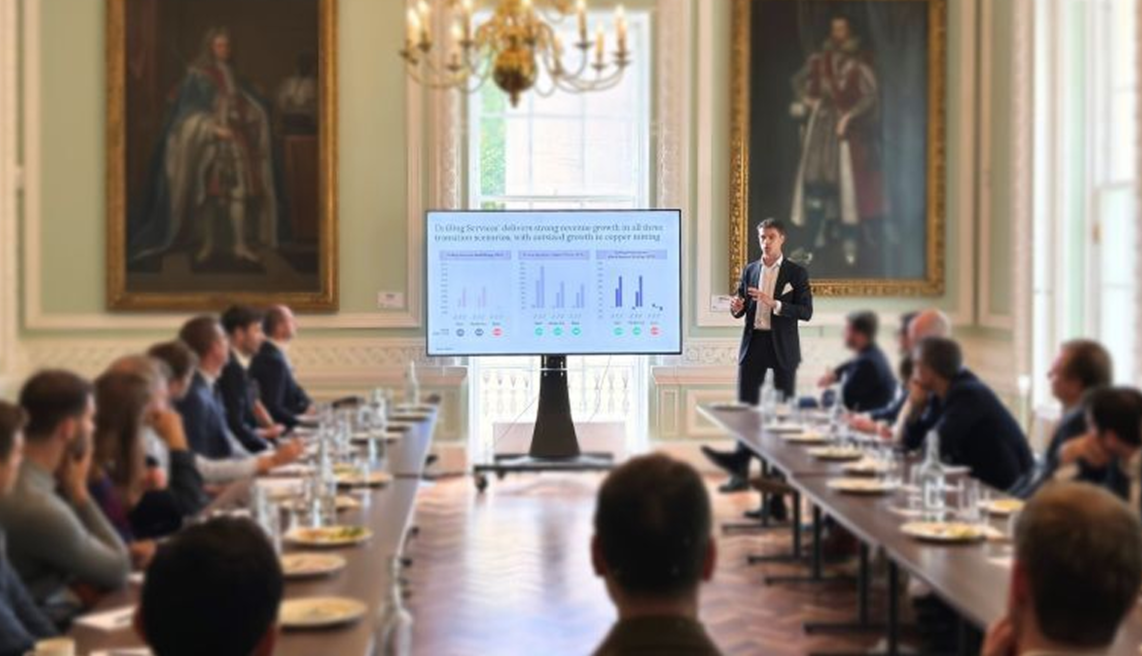 Alex Spencer presenting to a room full of attendees.