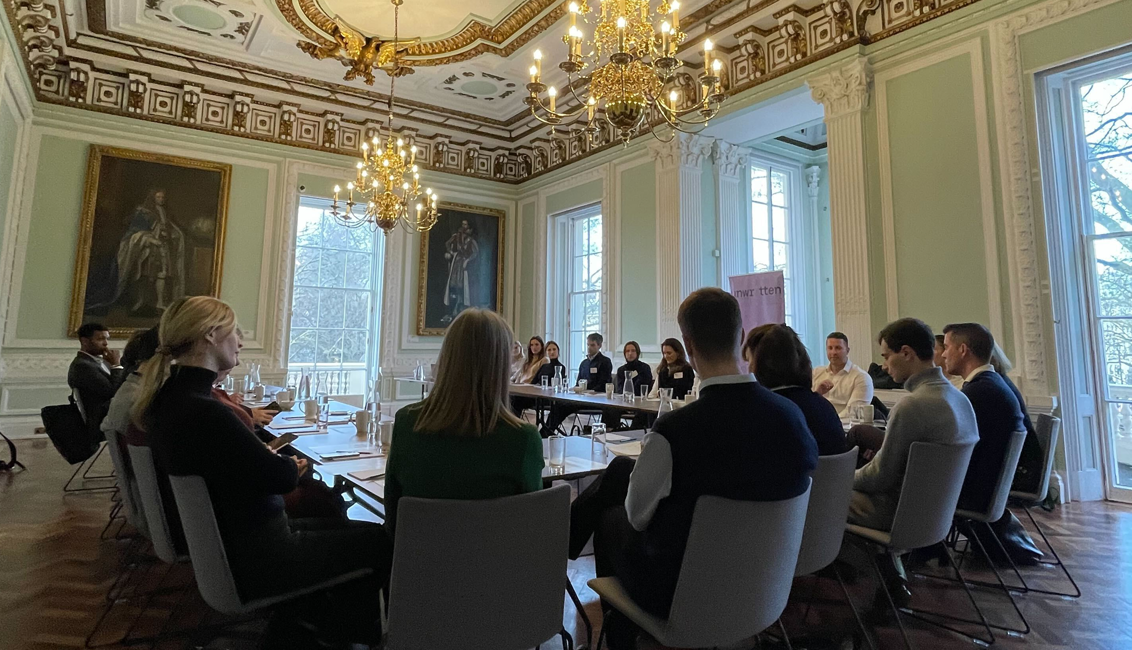 Participants sitting around a table discussing climate risk.