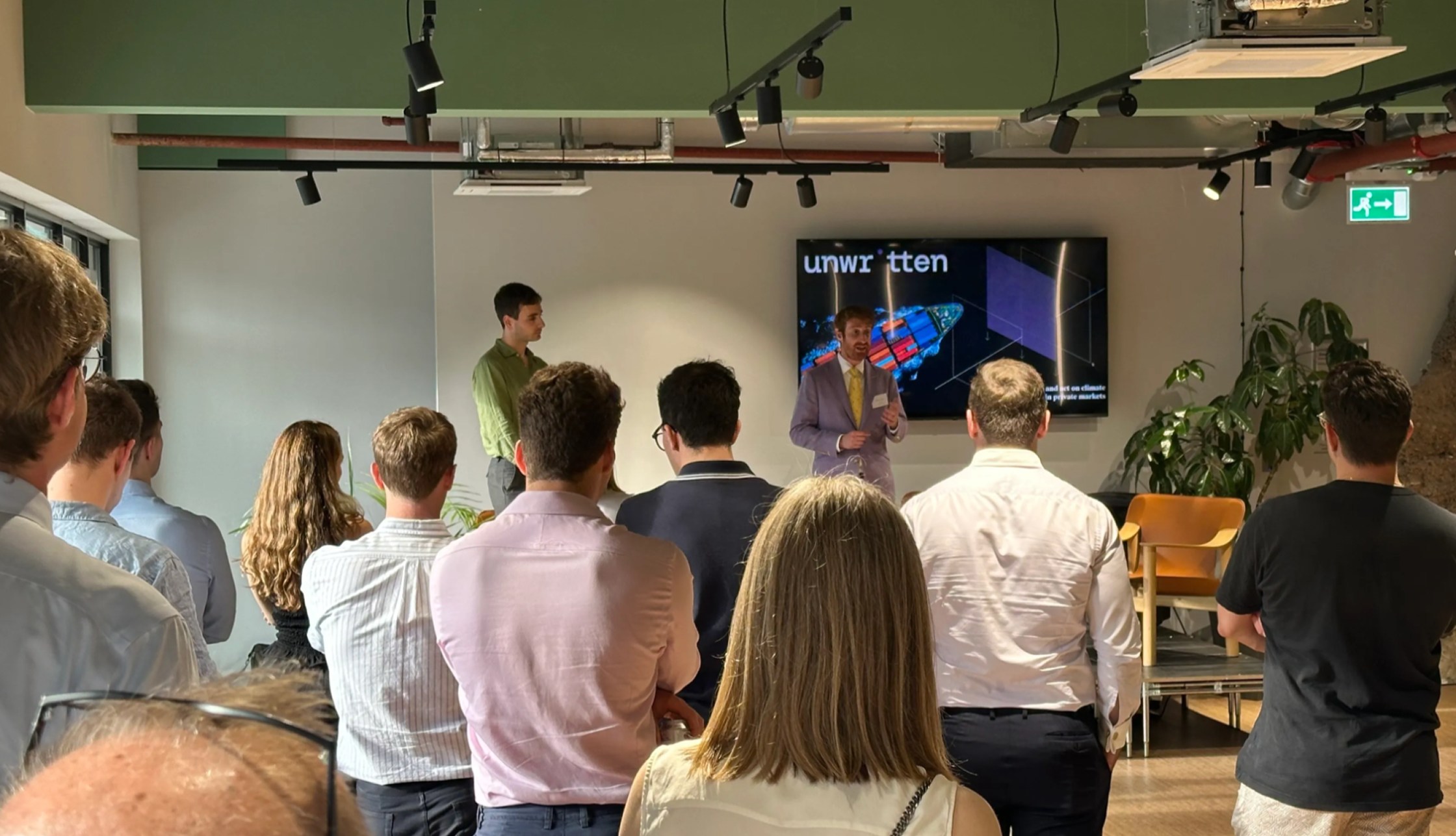 Amos Wittenberg (Unwritten CEO) and David Carlin speaking to a small crowd.