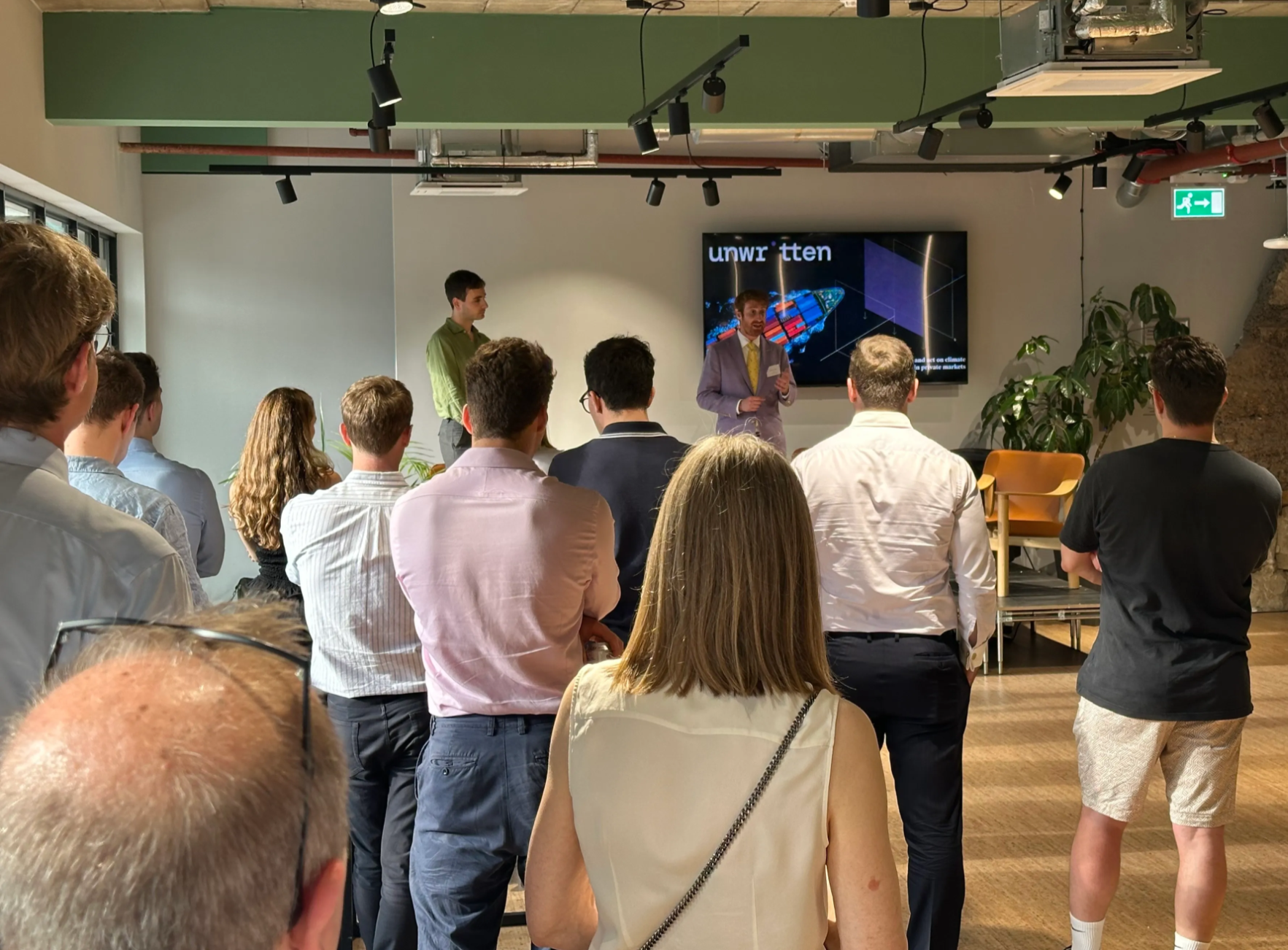 Amos Wittenberg (Unwritten CEO) and David Carlin speaking to a small crowd.